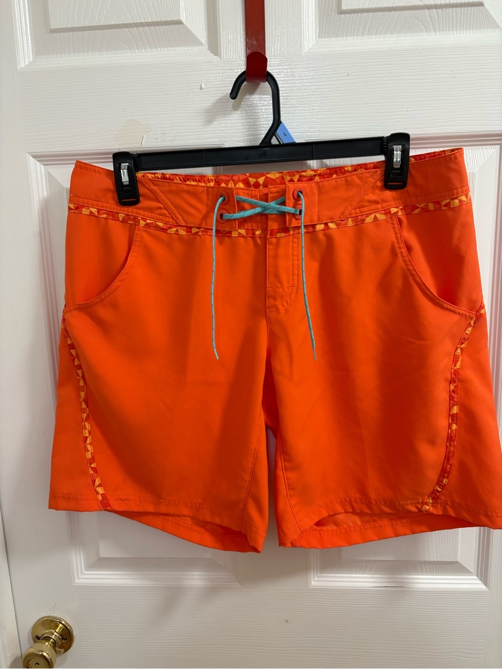 Columbia Women's Viva Bonita board shorts in a vibrant coral-orange color